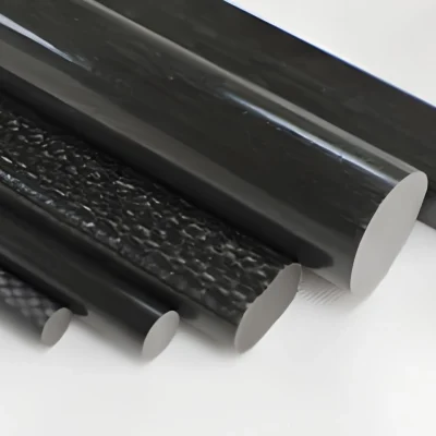 Close-up of several black cylindrical tubes of varying diameters arranged diagonally on a white surface.